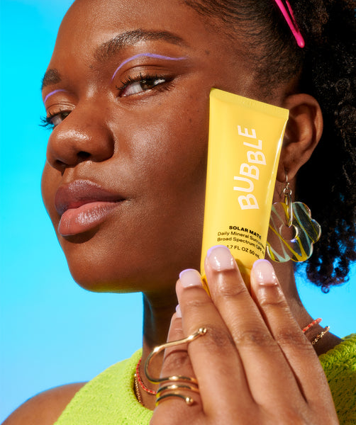 Woman holding daily mineral sunscreen SPF 40